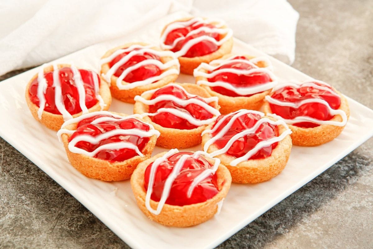 glazed cherry pie cookies on a square plate
