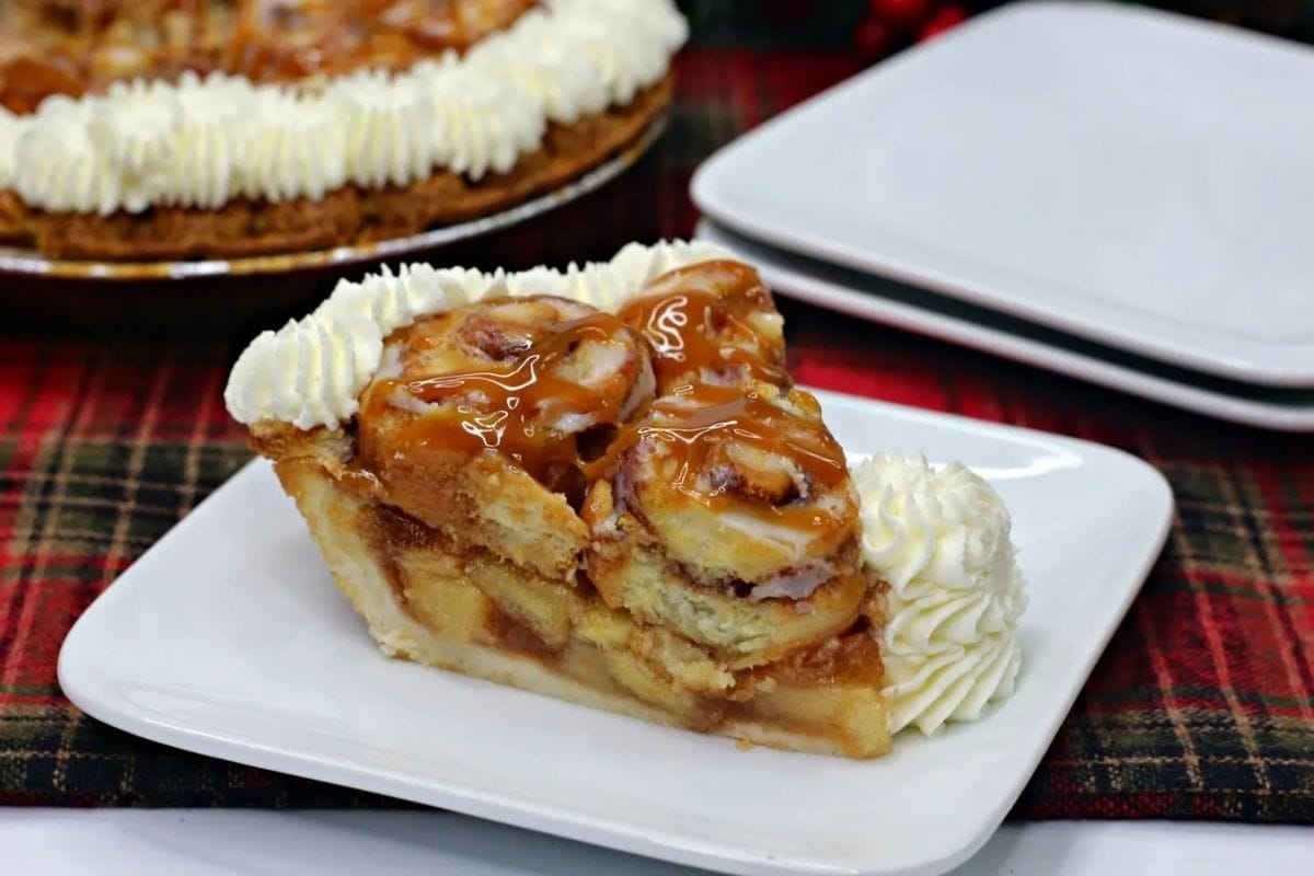 cinnamon roll apple pie sliced on a plate