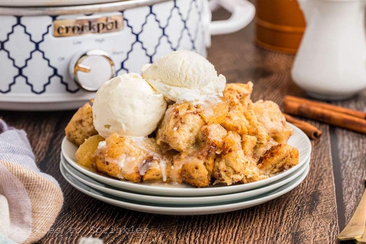 cinnamon roll casserole on a plate in front of a slow cooker
