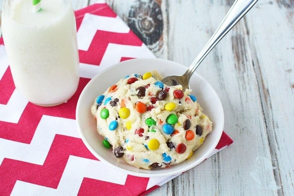 bowl of M&Ms cookie dough with a spoon