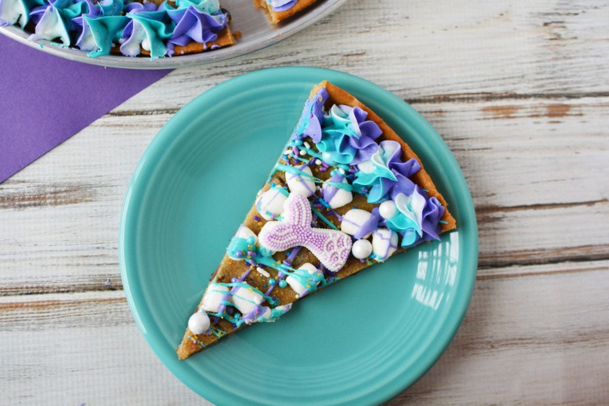 slice of mermaid cookie pizza on a blue plate