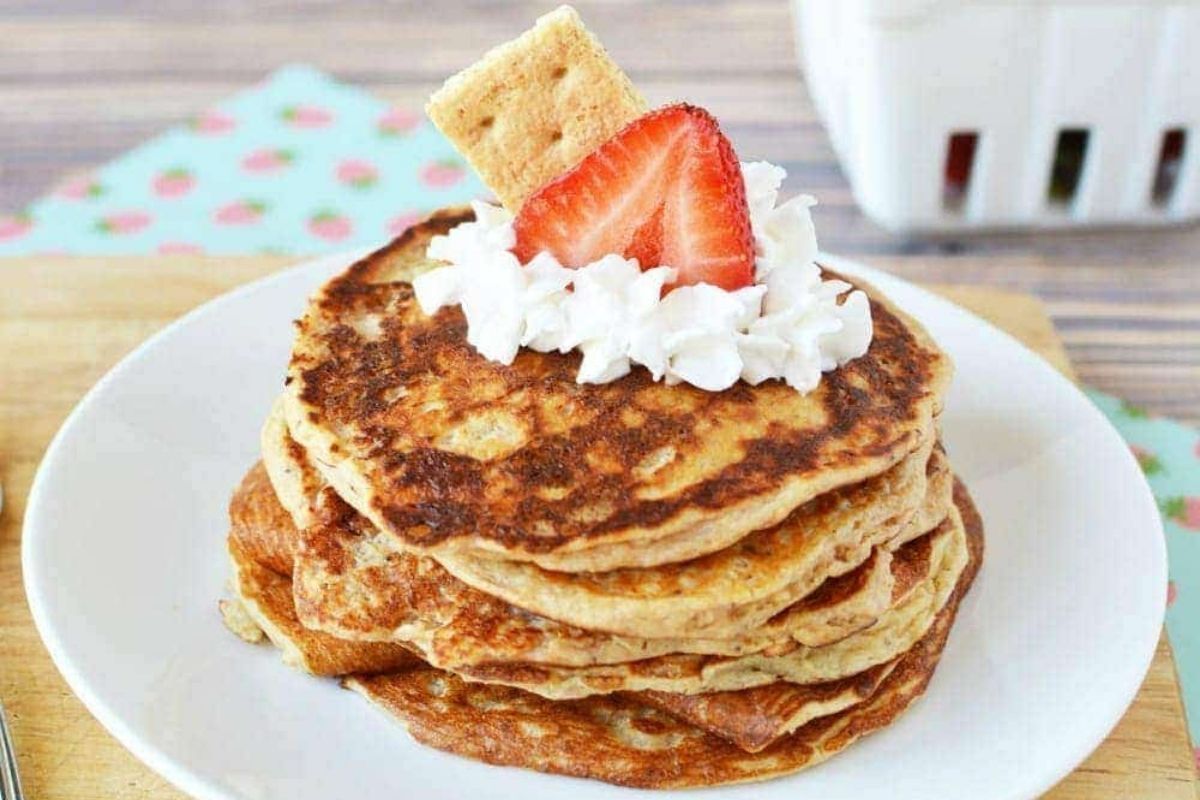 pancakes topped with whipped cream and strawberry