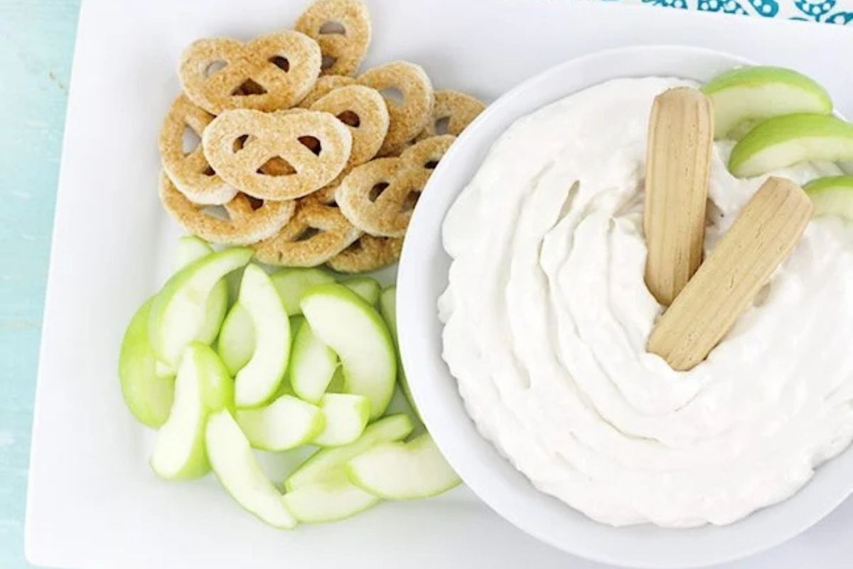 bowl of dip with apples and pretzels
