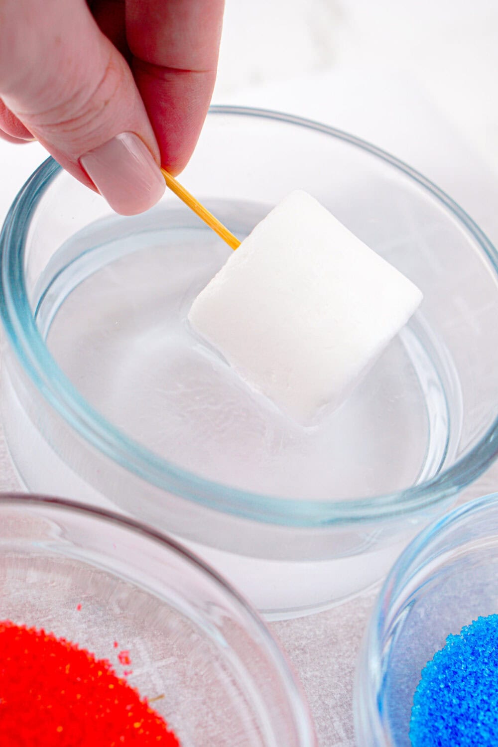 dipping a marshmallow into water