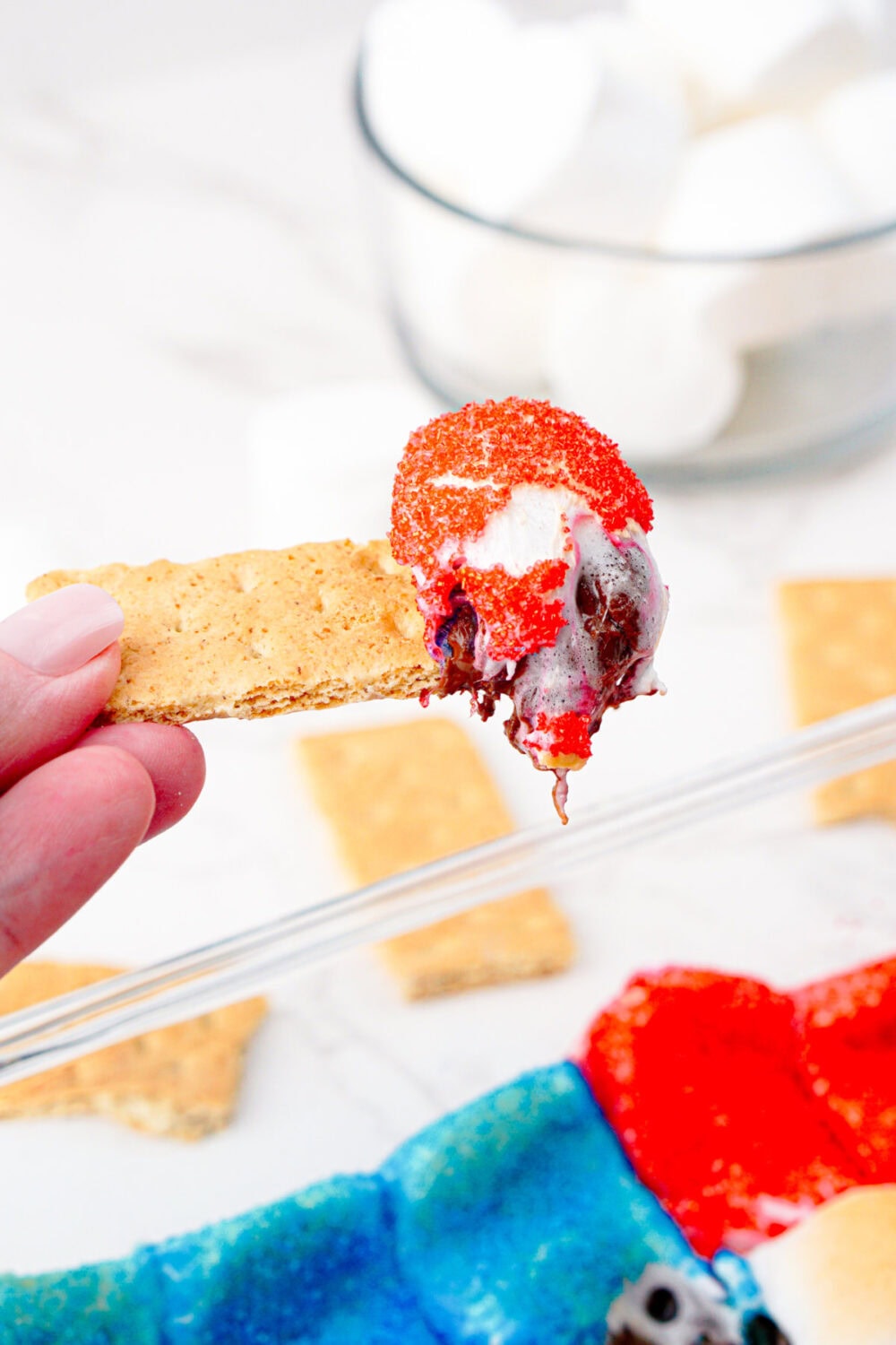 graham cracker that's been dipped in flag smores dessert dip