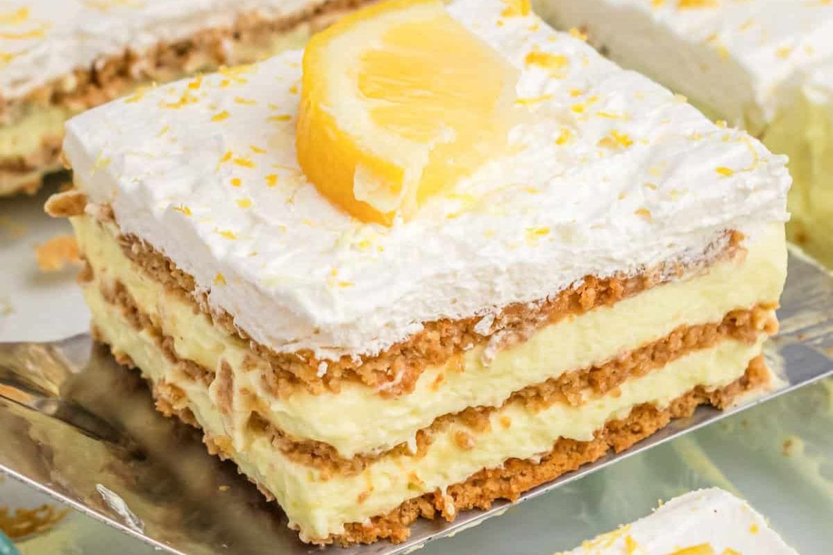 lemon icebox cake being lifted out of pan