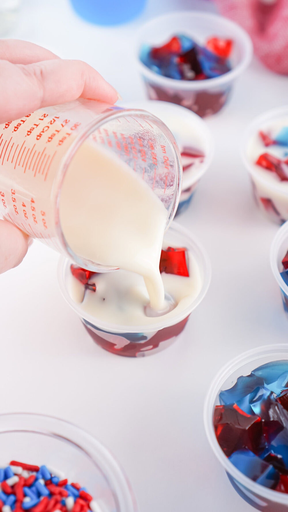 pouring milky layer into gelatin cups
