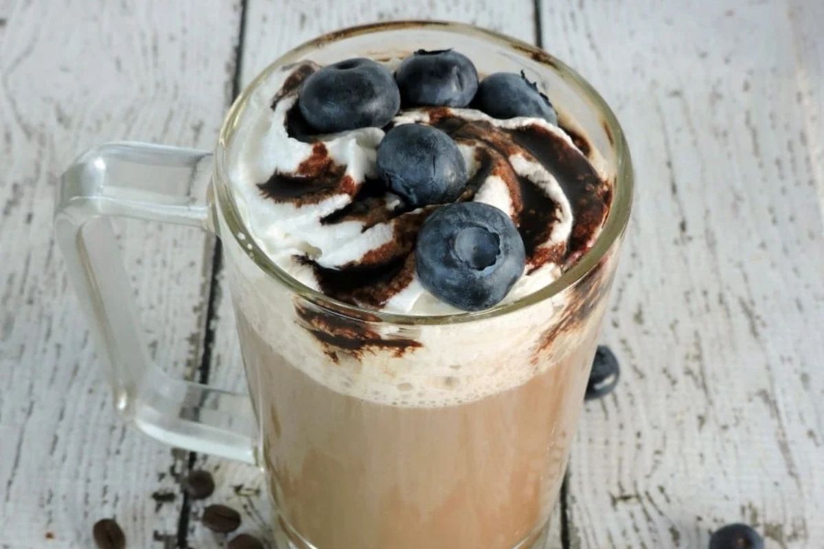 cappuccino topped with blueberries