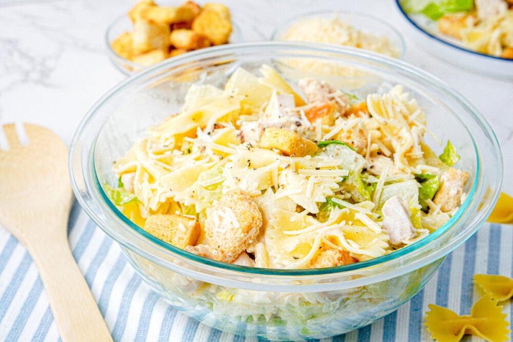 chicken caesar past salad in a clear bowl
