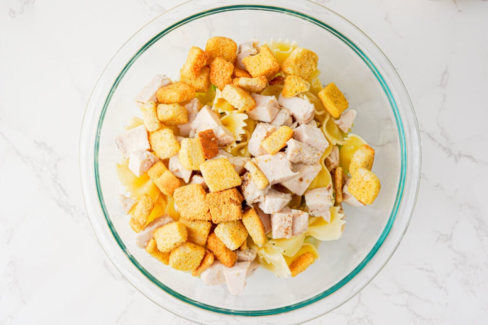 croutons, chicken, pasta in a bowl
