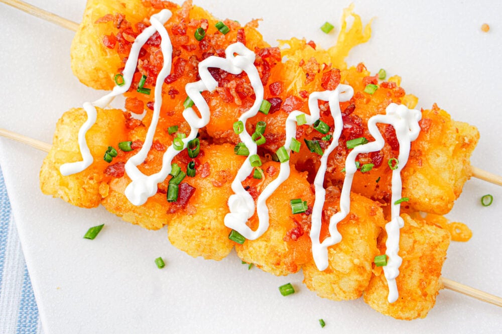 sour cream drizzled on loaded tater tots