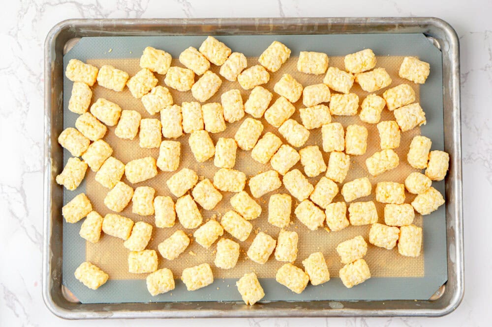 frozen tater tots on a baking sheet