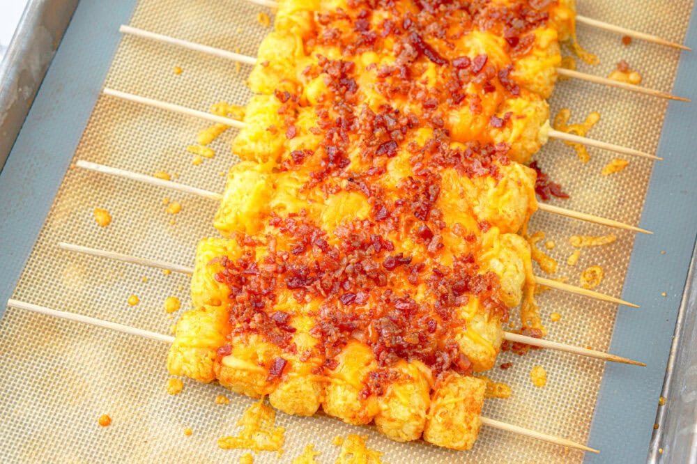 bacon crumbles on cheesy tater tot skewers