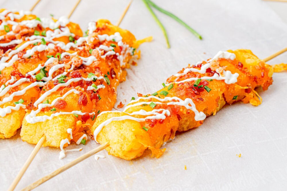 Loaded tater tot skewers on a table