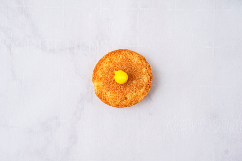 nilla wafer with a dot of yellow icing