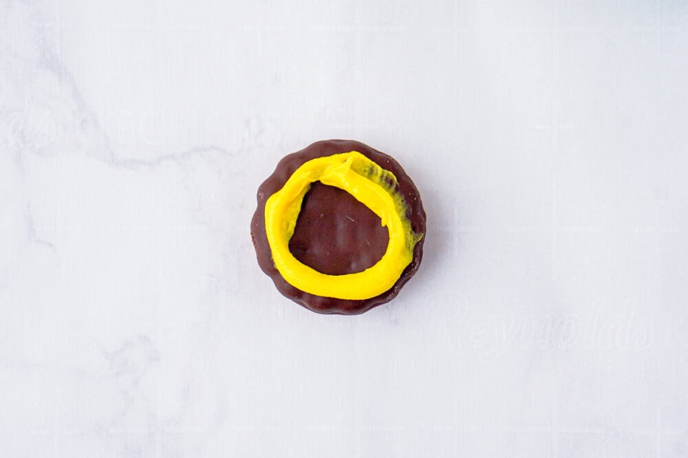 swirl of yellow icing on top of cookie