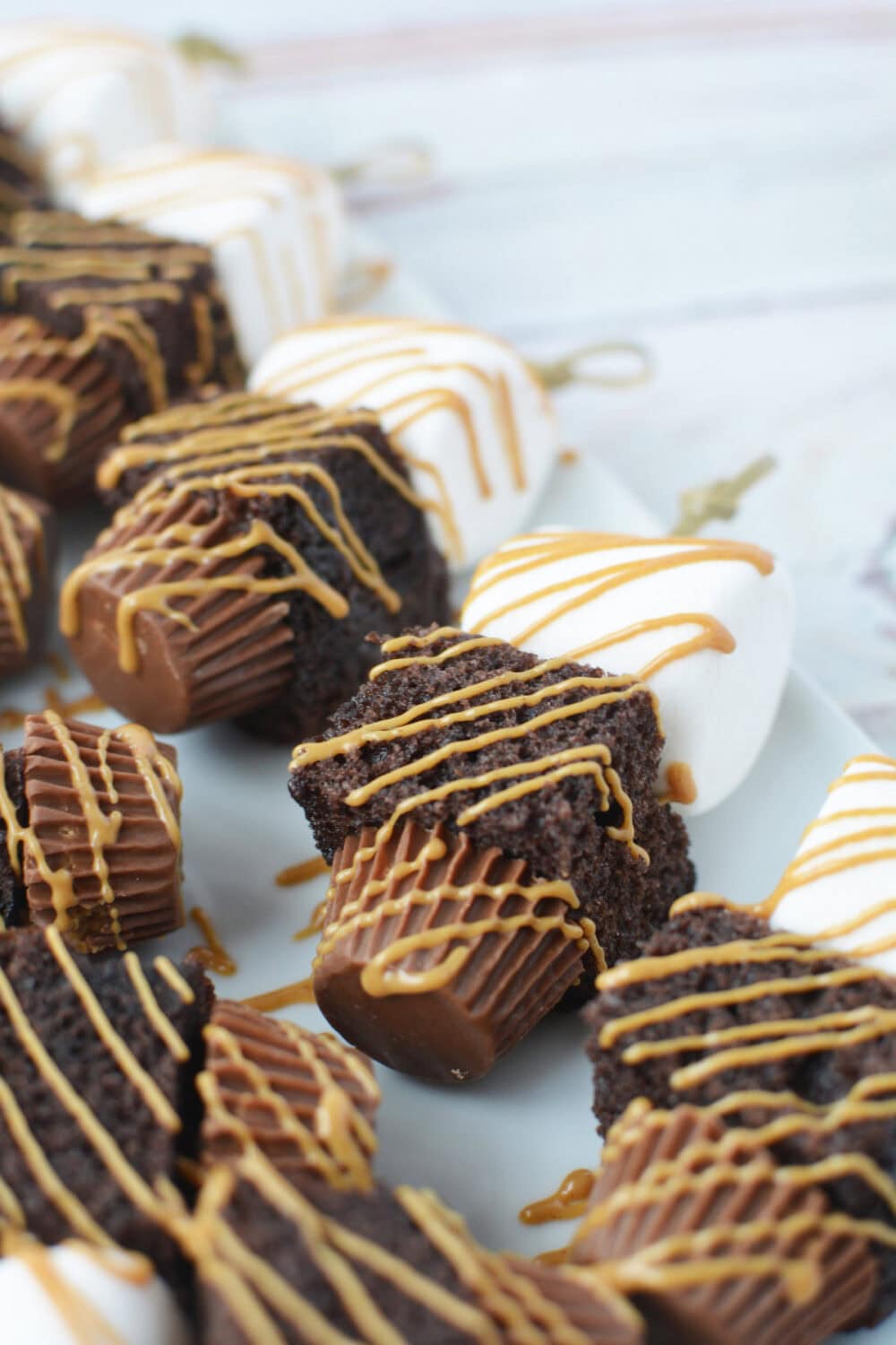 peanut butter drizzled onto peanut butter cup skewers