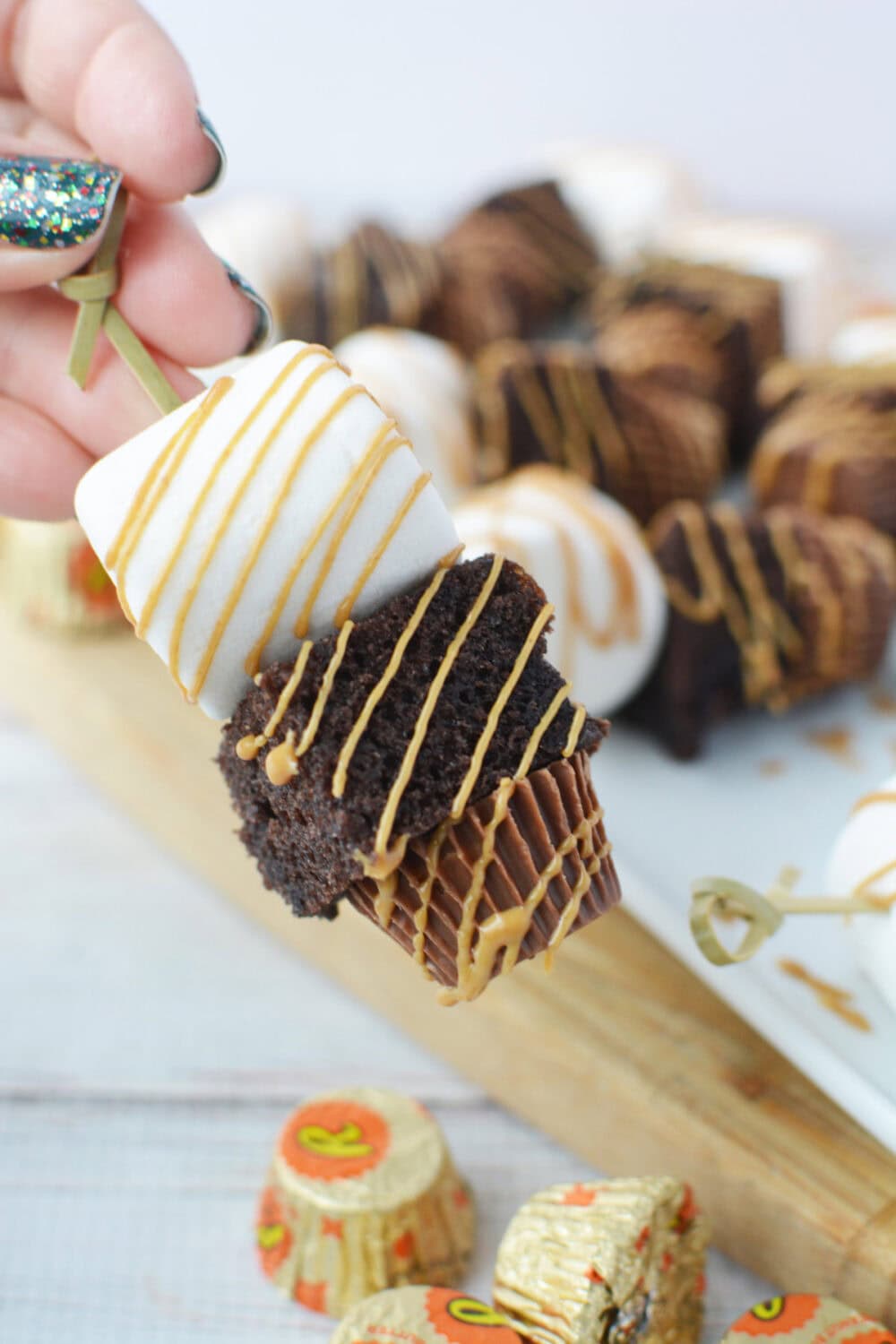 holding a mini peanut butter cup skewer