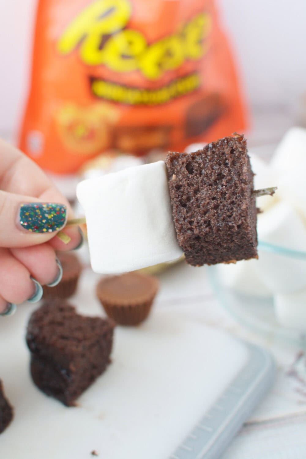 cake and marshmallow on a skewer