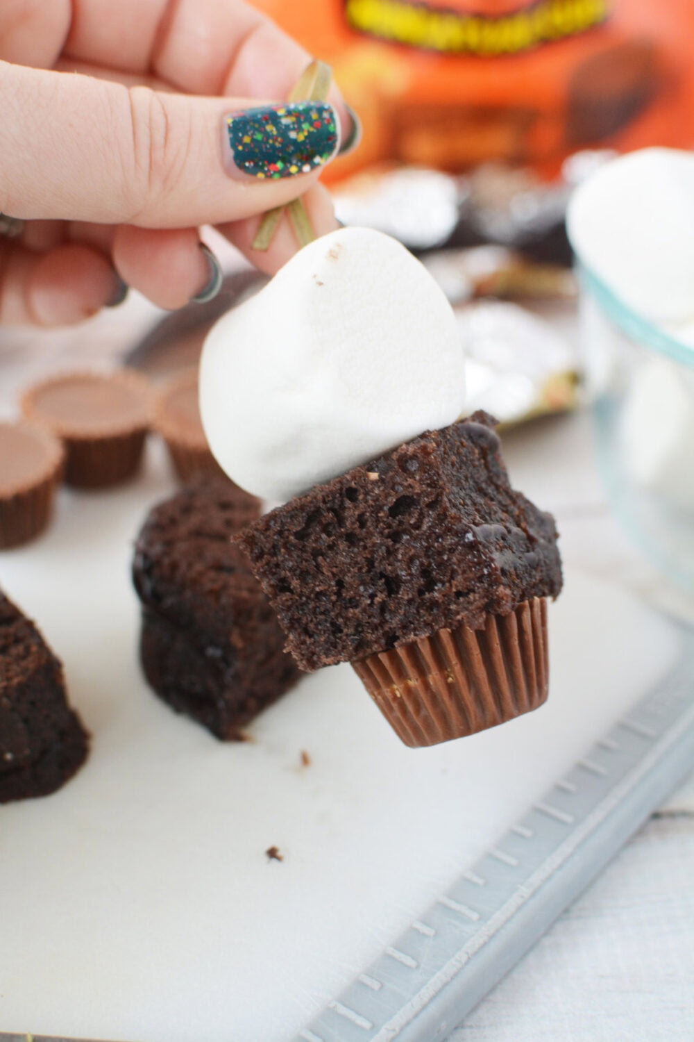 marshmallow, cake, and peanut butter cup on a skewer