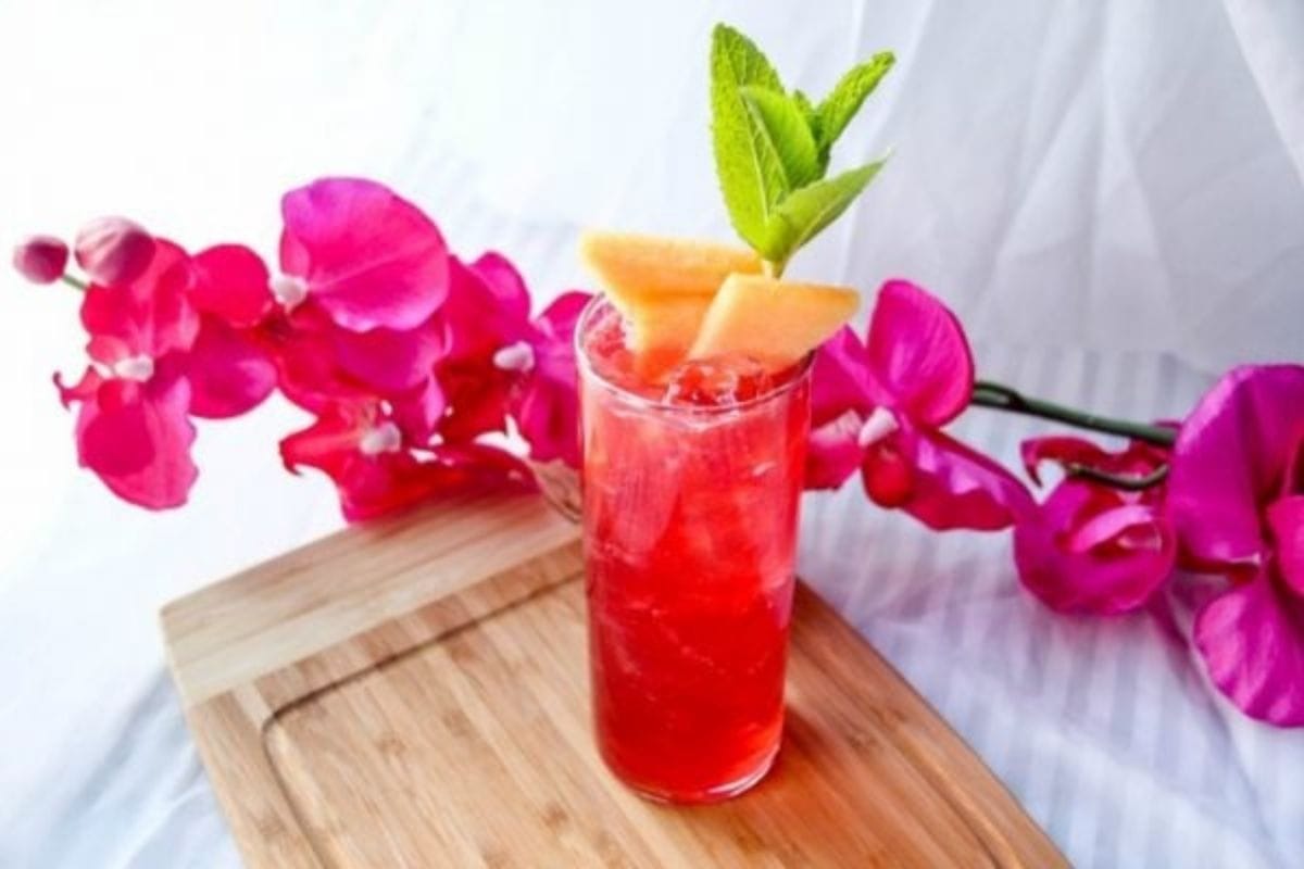 raspberry drink topped with canteloupe