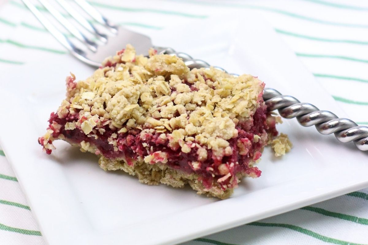 raspberry oatmeal bar sliced on a plate