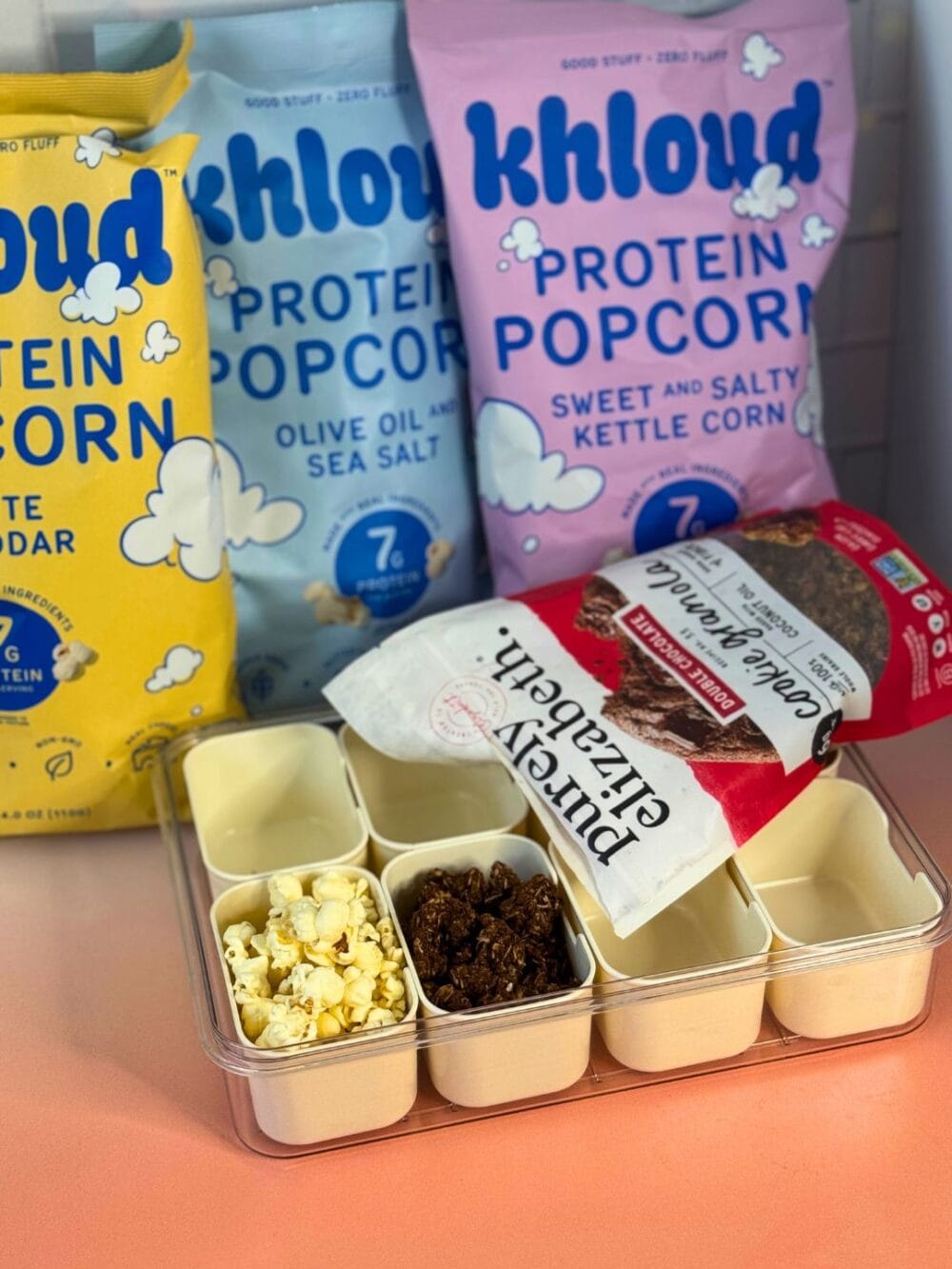 Khloud popcorn and granola filling a snacklebox