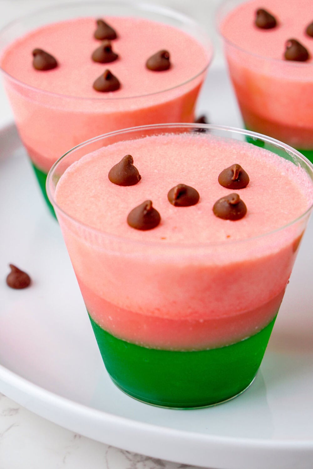 watermelon jello magic cups with chocolate chips on top