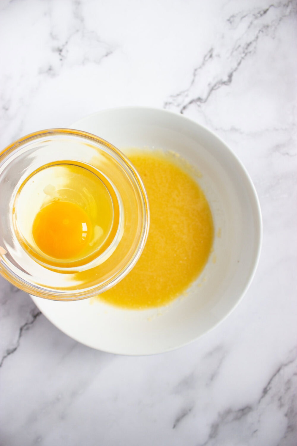 egg going into melted butter