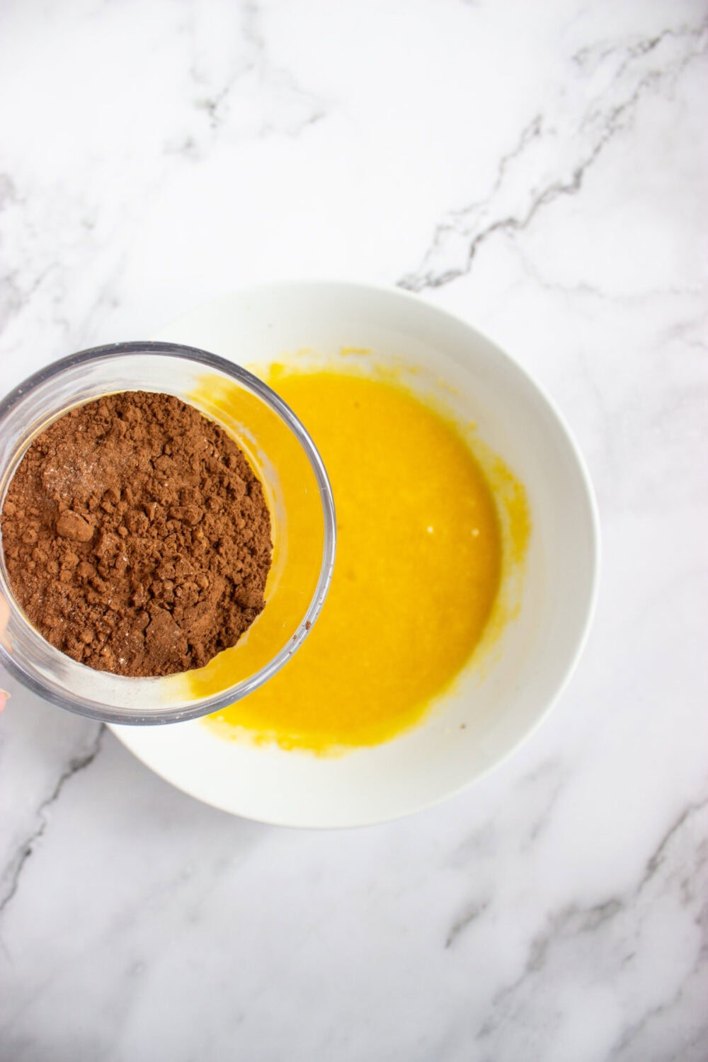 cocoa powder going into butter mixture