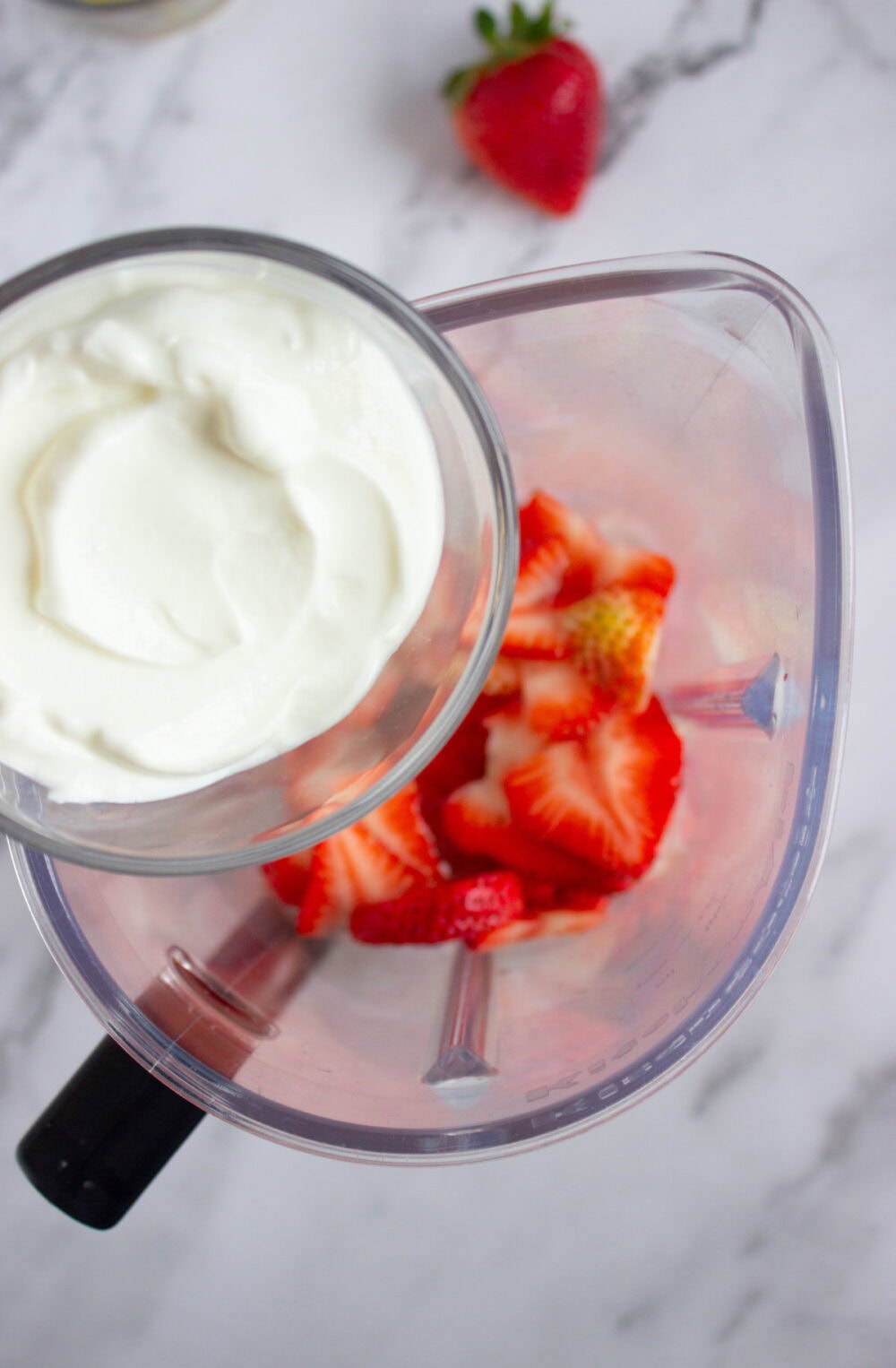 adding yogurt to a blender