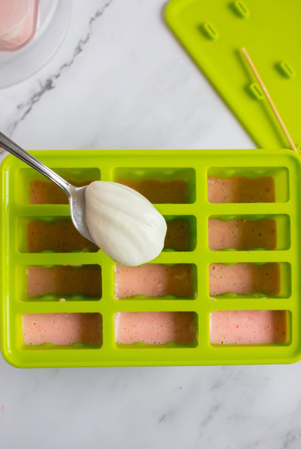 adding yogurt into popsicle molds