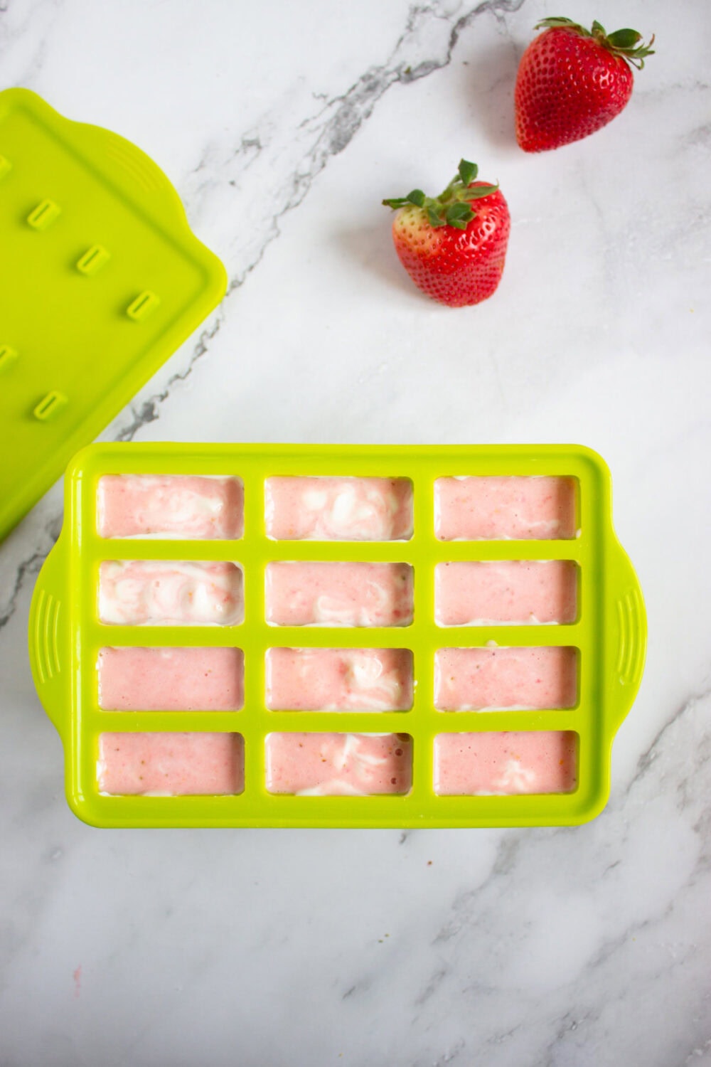 swirled strawberry yogurt pops in the mold