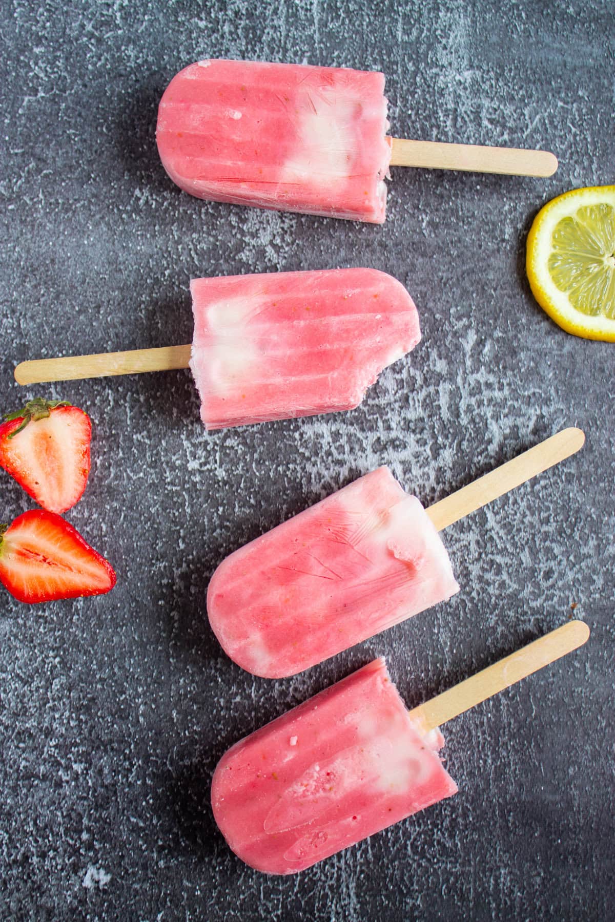 Strawberry lemonade popsicles on a table