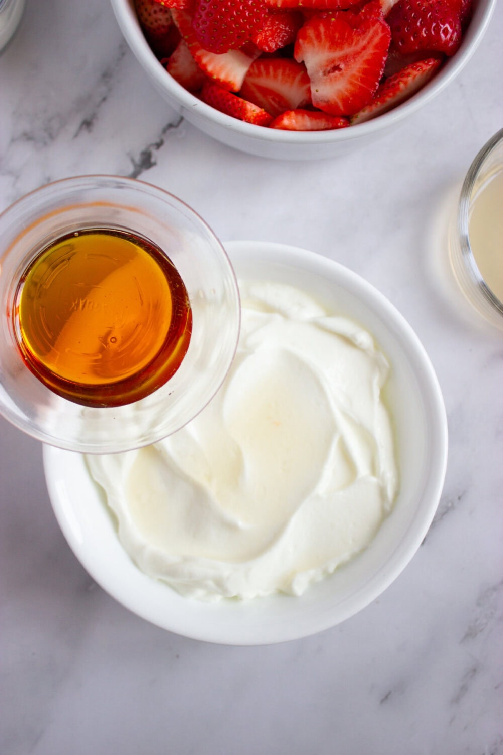 adding honey to Greek yogurt