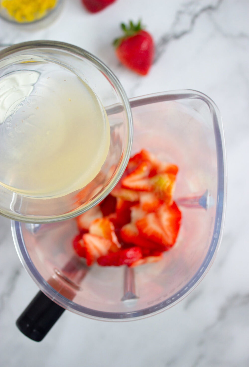 pouring lemon juice into a blender
