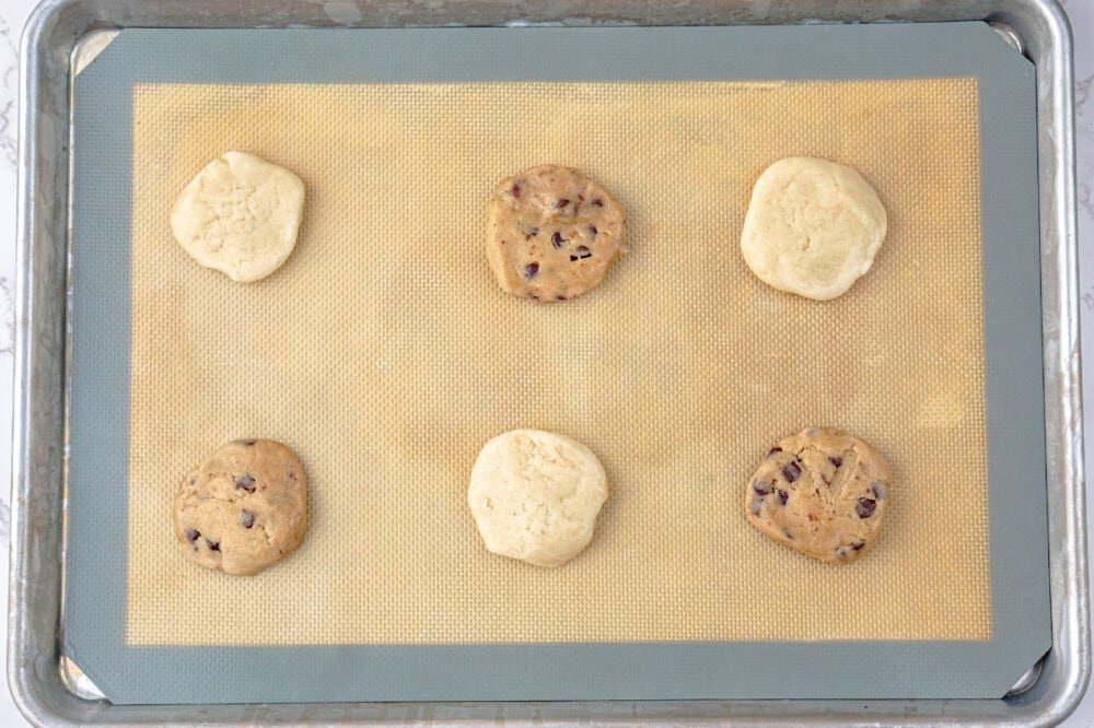 cookie dough rounds on a baking sheet